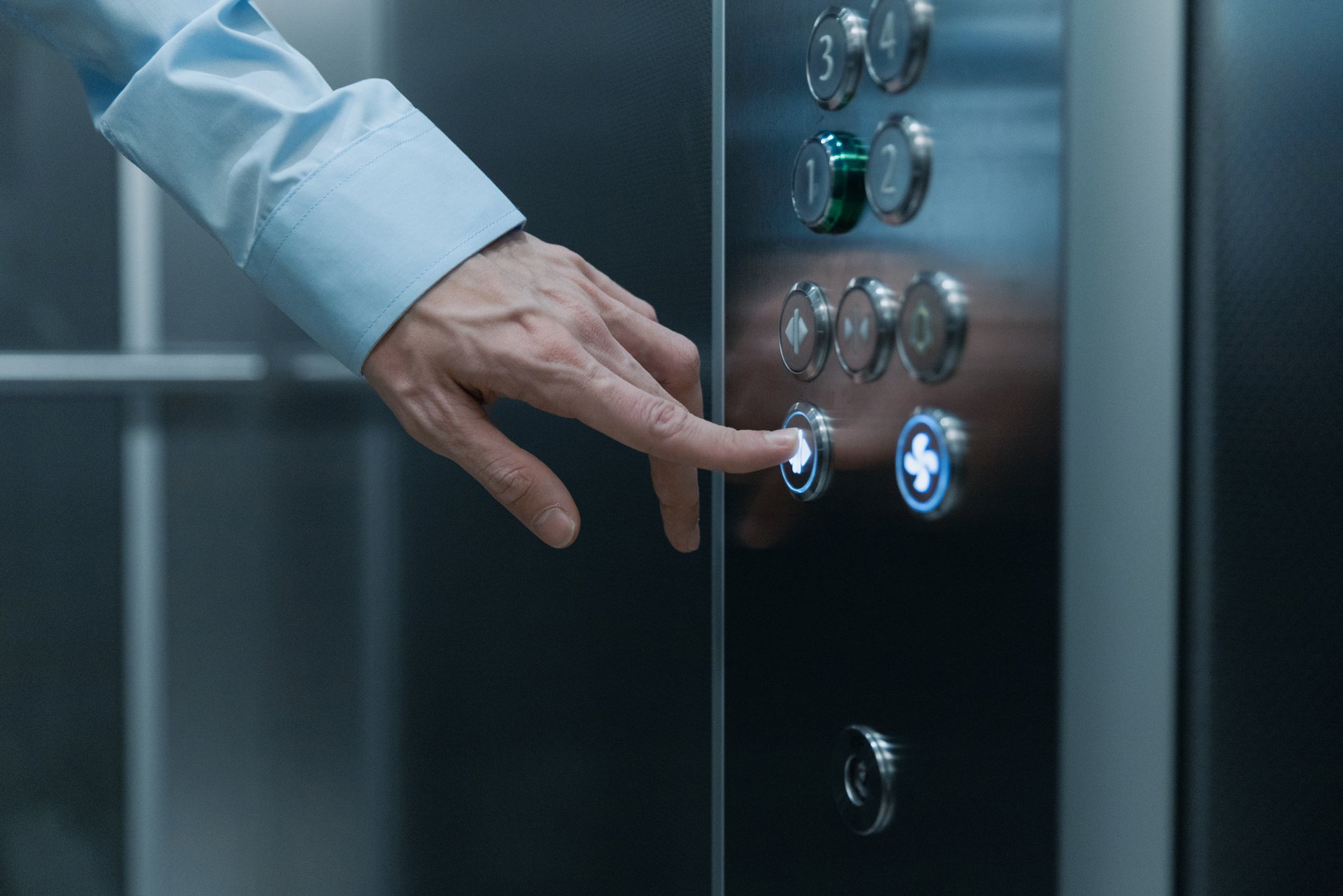 Close-Up Shot of a Hand Pressing an Elevator Button